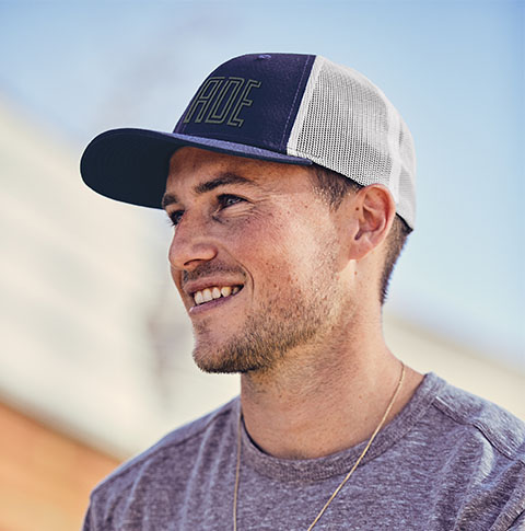 A smiling man in a ball cap